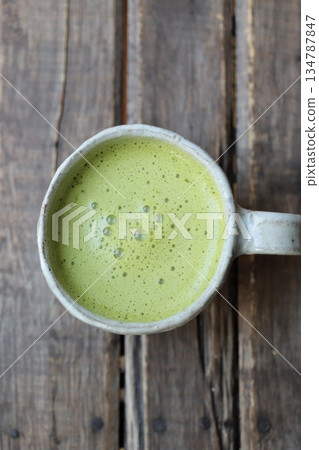 Matcha latte served in a cute, round, handmade cup Matcha latte served in a cute, round, handmade cup 134787847