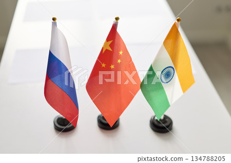 Desk flags for diplomacy on conference table, symbols of trilateral cooperation Desk flags for diplomacy on conference table, symbols of trilateral cooperation 134788205