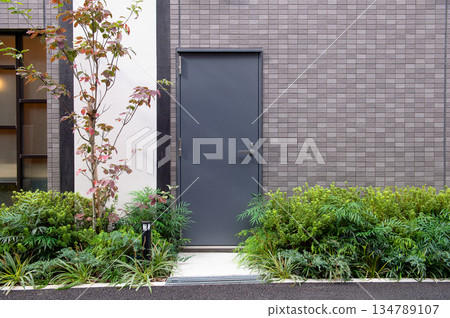 sidewalk by street wall and door sidewalk by street wall and door 134789107