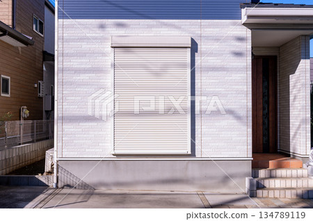 A closeup shot of automatic metal roller door used in factory, storage, garage, and industrial warehouse. The corrugated and foldable metal sheet offer space saving and provide urban and rustic feel A closeup shot of automatic metal roller door used in factory, storage, garage, and industrial warehouse. The corrugated and foldable metal sheet offer space saving and provide urban and rustic feel 134789119
