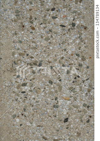 Concrete pavement surface with exposed aggregate pebbles, rough road texture 134789134
