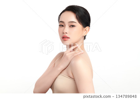 A beautiful young Asian woman with clean, fresh skin against a white background. Skincare, facial treatment, cosmetology, beauty, and spa. An elegant portrait of an Asian woman. 134789848