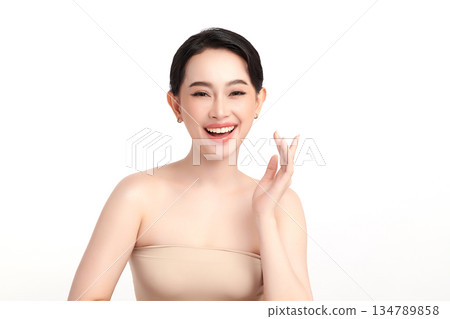 A beautiful young Asian woman with clean, fresh skin against a white background. Skincare, facial treatment, cosmetology, beauty, and spa. An elegant portrait of an Asian woman. 134789858