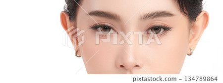 Close-up shot of beautiful Asian woman eyes on white background. 134789864