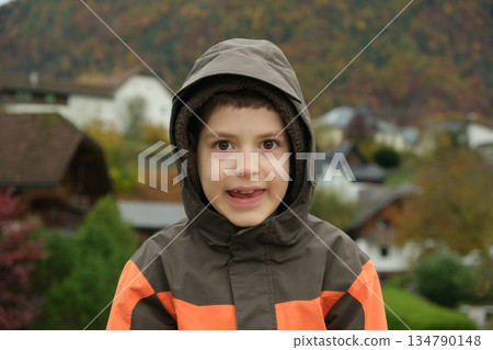 8 year old happy boy walking in autumn park, looking at camera 8 year old happy boy walking in autumn park, looking at camera 134790148
