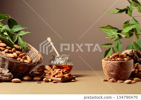 Almond nuts and honey on a brown background. 134790470