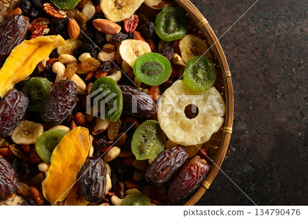 Dried tropical fruits with various nuts and raisins. Dried tropical fruits with various nuts and raisins. 134790476