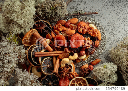 Dried fruits and nuts on a silver try. 134790489