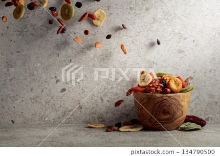 Mix of dried fruits and nuts on a gray stone table. Mix of dried fruits and nuts on a gray stone table. 134790500