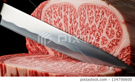Premium wagyu beef ribeye steak being sliced with sharp knife showing intricate marbling pattern and fat distribution on cutting board Premium wagyu beef ribeye steak being sliced with sharp knife showing intricate marbling pattern and fat distribution on cutting board 134790600
