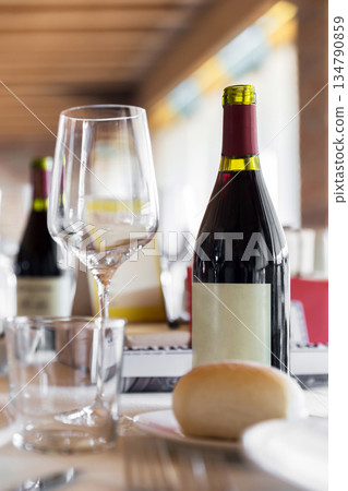 Elegant Wine Glass with Wine on a Table Elegant Wine Glass with Wine on a Table 134790859