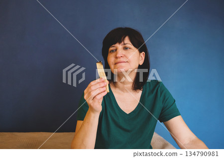 Woman holding burning palo santo wood, engaging in spiritual aromatherapy and meditation 134790981