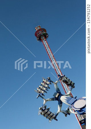 Teens on rides and blue sky on background Teens on rides and blue sky on background 134791252