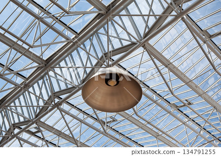 Lamp on the ceiling of a glass roof and blue sky in the background 134791255