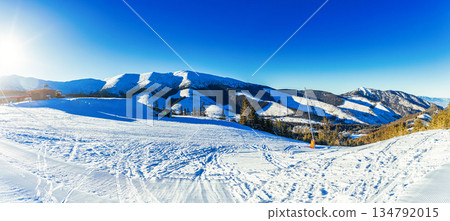 Wide Panoramic View of a Sunny Ski Resort in the Mountains 134792015