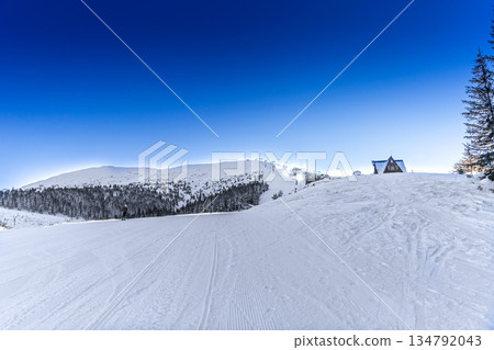 Winter Morning on a Ski Slope with a Mountain Cabin Winter Morning on a Ski Slope with a Mountain Cabin 134792043