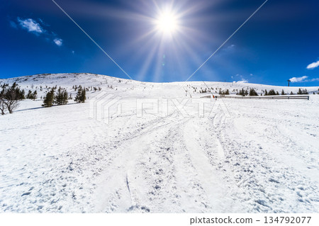 High Altitude Winter Sun Over Snowy Mountain Slope 134792077