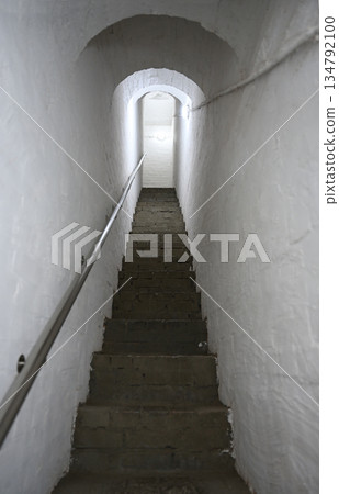 A narrow stairway in the wall of the old monastery 134792100