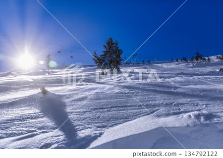 Winter Ski Slope with Chairlift and Wind-Blown Snow 134792122