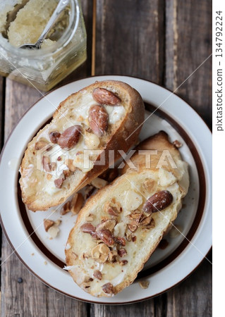 Mixed nuts honey butter tartine and a jar of honey, baguette open sandwich 134792224