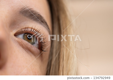 Close-up of a woman's eye after eyelash lamination procedure.  134792949