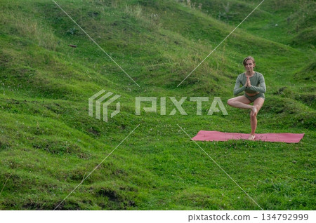 Caucasian woman doing yoga outdoors.  134792999