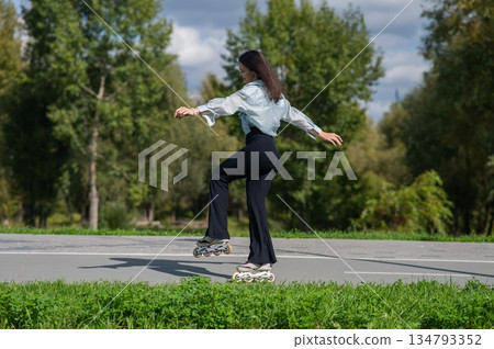 Caucasian woman roller skating in park. Caucasian woman roller skating in park. 134793352