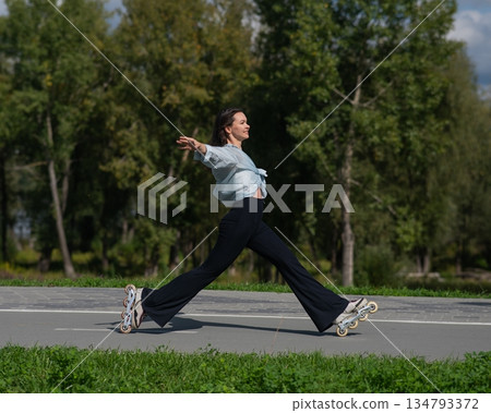 Caucasian woman roller skating in park. Caucasian woman roller skating in park. 134793372