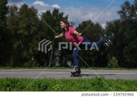 Caucasian woman roller skating in park. Caucasian woman roller skating in park. 134793466