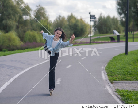 Caucasian woman roller skating in park.  134793474