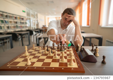 Middle aged Caucasian man playing chess.  134793987