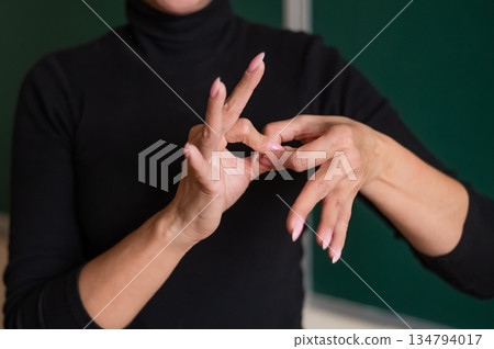 Woman showing the word connection in Russian sign language. Woman showing the word connection in Russian sign language. 134794017