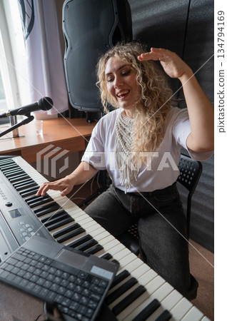 Caucasian woman teaches online music lesson.. Caucasian woman teaches online music lesson.. 134794169