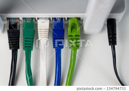 Colorful Ethernet Cables Connected to a Router.  134794731