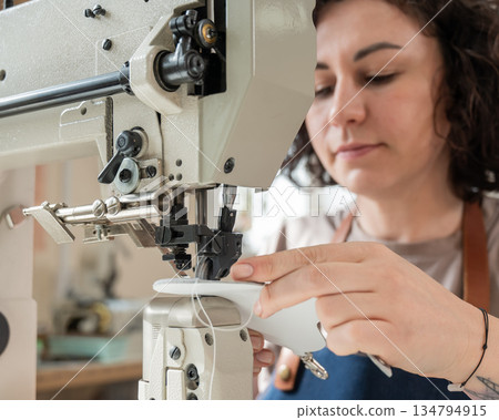 Woman tanner at work in the workshop. Woman tanner at work in the workshop. 134794915