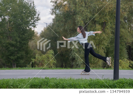 Caucasian woman roller skating in park. Caucasian woman roller skating in park. 134794939