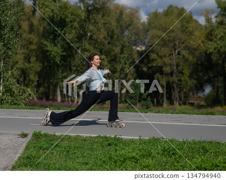 Caucasian woman roller skating in park.  134794940