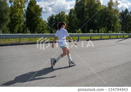 Caucasian woman in shorts roller skating. Caucasian woman in shorts roller skating. 134794943