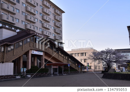 Inuyama City, Aichi Prefecture, Japan - During the Spring Inuyama Festival, Meitetsu Inuyama Station and the adjacent apartment building, cherry blossoms in full bloom and a beautiful blue sky 134795053