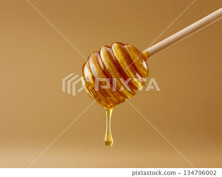 Honeycomb is shown with a honey drizzle on it 134796002