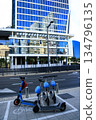 Electric scooters and modern glass building in Tel Aviv 134796135