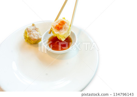 Top view of Shrimp dumplings in the yellow edge basket with chopsticks, focus selective Top view of Shrimp dumplings in the yellow edge basket with chopsticks, focus selective 134796143