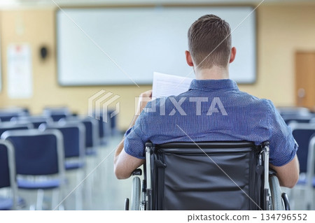 Student in wheelchair attending lecture in university classroom setting Student in wheelchair attending lecture in university classroom setting 134796552