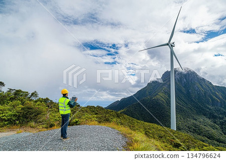 Engineer Monitoring Mechanical Performance of Wind Turbine in Scenic Mountain Landscape 134796624