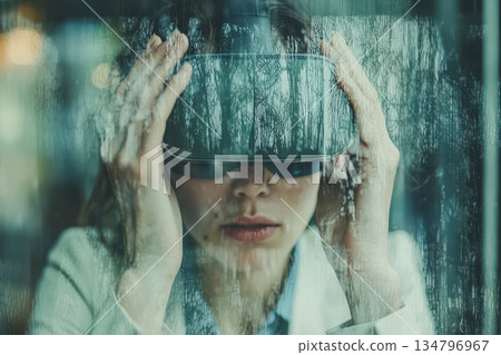 Woman Engaged in Immersive Experience with Augmented Reality Glasses 134796967