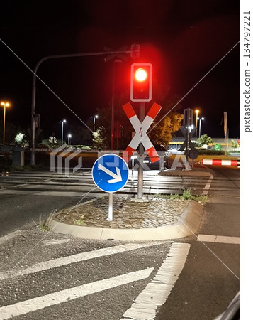 Red traffic light and railroad crossing sign at night Red traffic light and railroad crossing sign at night 134797221