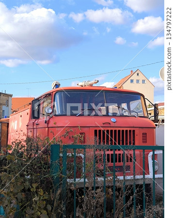 An old red fire truck in an abandoned parking lot in the countryside An old red fire truck in an abandoned parking lot in the countryside 134797222