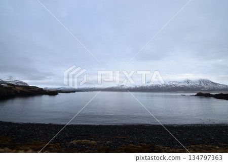 寧靜的歐洲湖泊和壯麗的山景。神秘的北歐荒野在陰雲密佈的天空下綿延展開。 134797363
