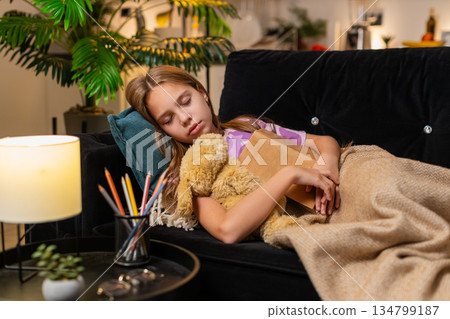 Teenager girl dozes off while reading favorite book slow blink sleepy eyes calm nap soft rest night 134799187