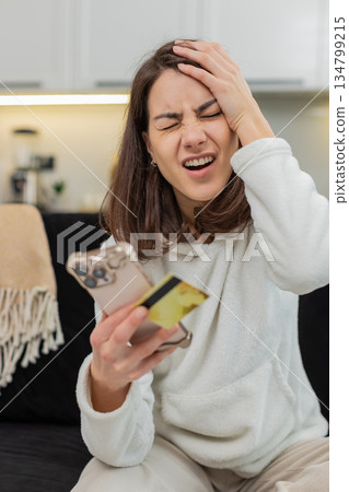 Young woman sees payment fail on smartphone blocked card suspected fraud panics calls support help 134799215